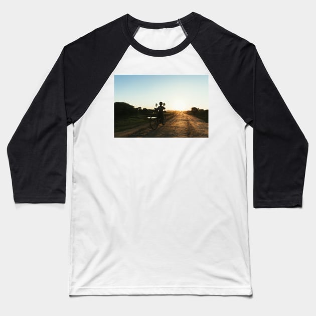 Silhouette of Boy Riding Bicycle at Sunset in Burmese Countryside Baseball T-Shirt by visualspectrum